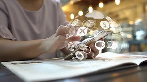 Hand touch screen smart phone, social icons interface on screen, connect to the future concept.