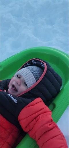 brave baby having snow board