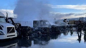 Smoke billows into the air after several big rig trucks catch on fire in Oakland, CA