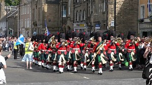 Film showing part of the afternoon procession during the historic Linlithgow Marches in June 2022. The parade, led by flag bearers and Linlithgow Reed Band, marched along the High Street and around the Cross in front of the Burgh Halls, then returned along the High Street. This wonderful day of marches and music returns to linlithgow on Tuesday 13th June 2023. This was the second of the three circuits completed during the marches. Following the flags and Reed Band were horse drawn carriages with