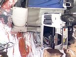 Truck carrying paint rolls and spills across a busy highway