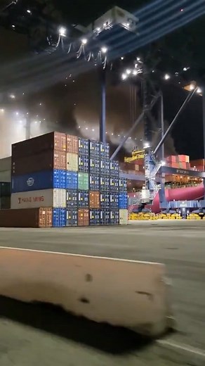 An electrical fire and explosion erupted aboard the Panamanian-flagged container ship One Henry Hudson while docked at the Port of Los Angeles, authorities said. The vessel had recently arrived from Tokyo when the blaze broke out, prompting a swift emergency response. All 23 crew members were safely evacuated with no reported injuries, officials confirmed. Firefighters battled intense flames that spread across multiple decks, using cranes to deploy hoses amid stacked containers. The incident tri