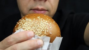 Man eating big burger. Hungry man eating big hamburger
