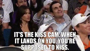 It's the kiss cam. When it lands on you, you're supposed to kiss.