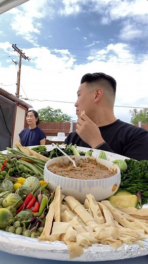 Eating Assorted Steamed Veggie Platter with Spicy Fermented Fish Sauce Dip (Jeow Pa Daek) made with Shallots, Garlic, Chilies, Galangal, and Cherry Tomatoes. Sometimes the most Simplest Meals are the Best Meals. This was great way to get in my Veggies. This was so awesome to Visit Family. So much great food 😋🙏🏻🙌🏻. Khop Jai Der Aunty, Uncles, and Cousin’s. | mrintharriss