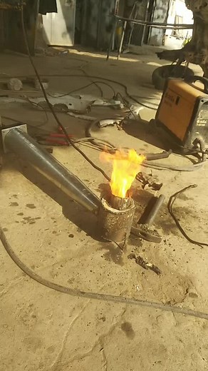 Welding Rusty Steel Pipe in an Outdoor Workshop