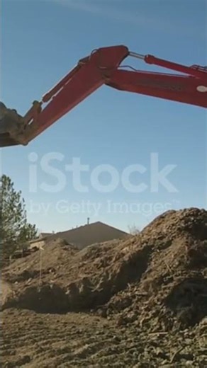 Bucket of backhoe digging soil at construction site. Crawler excavator digging. Excavating machine