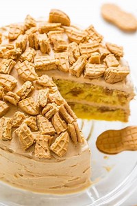 Nutter Butter Peanut Butter Layer Cake - Soft yellow cake with Nutter Butters baked in AND sprinkled on top!! The peanut butter FROSTING is rich, creamy, and decadent! Peanut butter fans will LOVE this cake!! RECIPE https://www.averiecooks.com/2017/07/nutter-butter-peanut-butter-layer-cake.html | Averie Cooks