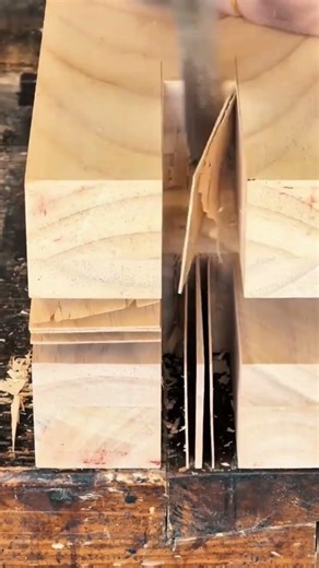 carving and hollowing out deep rectangular slots in a thick wooden block using a sharp hand chisel
