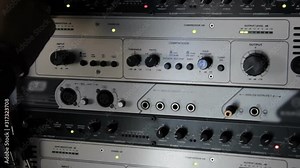 A rack of audio compressors and other components of sound reinforcement system in a recording studio close up. Sound engineer adjust paameters with knobs.Making music in the professional studio.