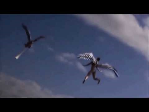 Two Angels are flying in the sky and landed on a building's roof