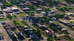 Aerial view of a suburban neighborhood in an american city, showcasing residential areas, streets, and greenery from different angles
