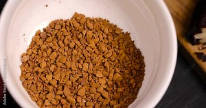 preparation of coffee soluble in boiling water in a white cup, freeze-dried granules