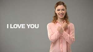 Deaf woman saying love you in sign language, text on background communication