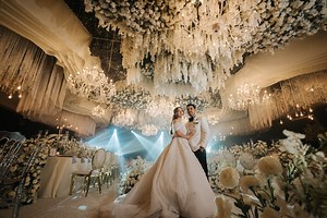 Step into a reception woven in white and wonder ✨✨✨ For this unforgettable wedding reception, we embraced timeless elegance with a modern midnight twist. The venue bloomed with classic white florals - lush arrangements cascading from every corner, soft petals gracing each table, and delicate blooms suspended above like whispers of romance. As guests entered, they were immersed in a dark, romantic ambiance that made every detail glow. Overhead, a canopy of fairy lights shimmered like stars caught