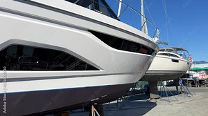 Rich life of luxury granville island Two beautiful ships stand on a raised platform prepared for repairs good weather bright clear sky Yacht travel Canada Vancouver 09.2022
