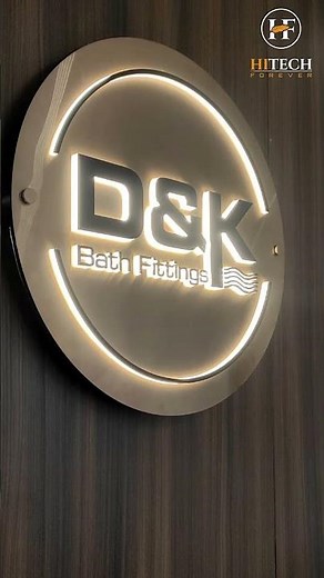 A beautiful circular LED nameplate in rose gold stainless steel, topped with bold black letters