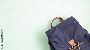 Stop motion animation with blue backpack and school supplies entering inside the bag. Back to school, education, childhood, primary school concept