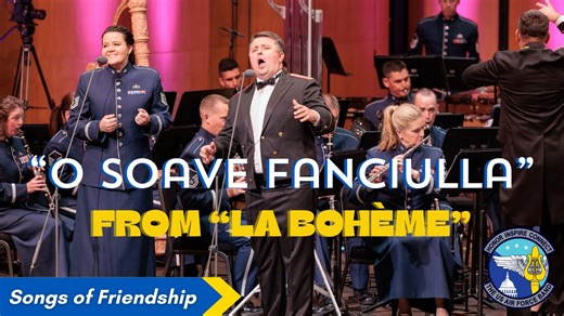 O GENTLE MAIDEN | The romantic duet "O soave fanciulla" ("O gentle maiden") from Giacomo Puccini's 1896 opera, "La Bohème", occupies a central position in act 1. Sung as the concluding piece of act 1, the characters Rodolfo (tenor) and Mimì (soprano) convey their profound realization of falling deeply in love with each other. Enjoy "O soave fanciulla" sung by our very own soprano Technical Sgt. Nicole Vander Does, and guest tenor soloist Mr. Serhii Hurets. This performance was recorded at the Ra