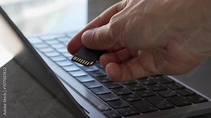 Chip for storing information. Office worker with SD memory card in hand. Storing important information on flash drive. Using and transferring media data