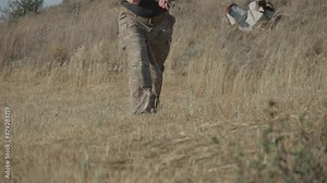 Soldier with uniform leaving the gun in the battle field and running. Slow motion