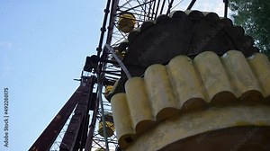The abandoned ferris wheel cabin in Pripyat from below. Metal rusty structures of the Soviet attraction. High quality 4k footage