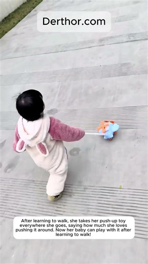 After learning to walk, she takes her push-up toy everywhere she goes, saying how much s
