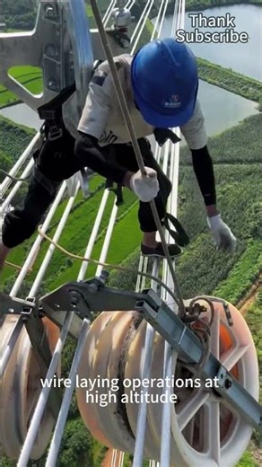 Electric workers pull the wire pulley to perform wire laying operations at high altitude
