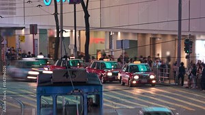 Hong Kong Street With Trams, Buses and Pedestrians at Night. Nighttime Urban Energy Pulsing Through Hong Kong City Street, Bustling With Trams, Double-decker Buses Stock Video