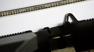 Typing the word CORRECT with an old manual typewriter