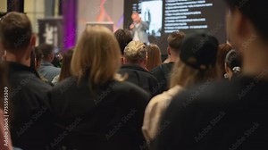 Speaker at technology event unveils innovations to eager entrepreneurs in conference setting. Creative minds absorb new technological insights during innovation keynote in a bustling conference room.