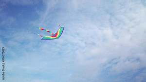 Footage of flying kite in the air with beautiful blue sky in background.