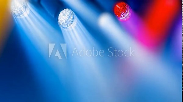 Stage Spotlight Symphony: An array of vibrant spotlights illuminates a stage. The radiant beams of light create a dynamic and energetic visual. The image captures the vibrancy and energy. vídeo de Stock