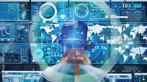 Industrial engineer in a hard hat and headset monitors production on screens in a control room with data visualizations Stock Video