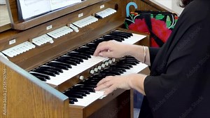 organist playing the organ during funeral service