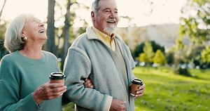 Senior couple, coffee and park walk with love, discussion and smile outdoor. Conversation, hot drink and marriage of elderly people together on a happy date in nature with communication in garden