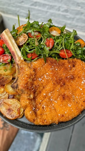 Home Cooking Sessions: Veal Milanese. Served with crispy potato’s and a very simple rocket salad. Full recipe below! 👇🏽😍 - 1. Get yourself a nice bone-in veal loin chop. Cut into chops. About one meaty chop per person is good. 2. French trim the bones by scraping with a knife, then place down and lay over some cling film 3. Use a mallet or rolling pin to pound out the meat evenly till nice and thin. I like mine ultra thin, even less than 1/4 inch. Like super thin. Go thinner than you think 4.