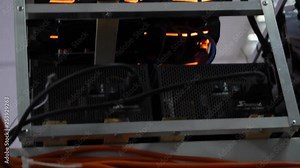 Close-up of mining farm. Electronic computer devices with fans and graphics processors with video cards for mining farms and cryptocurrencies