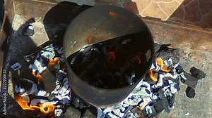 Using the wind funnel so the fire for the BBQ could get the heat into the charcoal to cook the food.