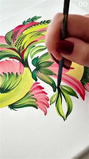 Hand paints vibrant bird with floral accents.