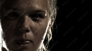 A female athlete breathes heavy and sweats after an intense exercise