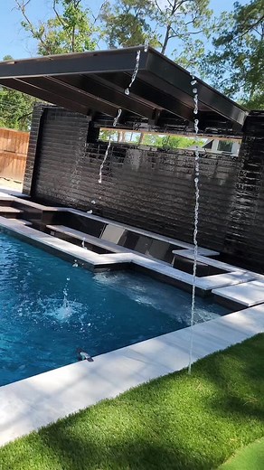 Ultra Custom Builds on Instagram: "This backyard is on another level 🤯🔥 Custom cantilevered metal patio structure ✔️ Sunken fire pit with a water wall backdrop 💦🔥 Modern pool, putting green, and tons of turf 🏌️‍♂️🌿 Clean lines. Sleek design. All custom. Houston’s modern backyard game = changed 💯 📍 Built by Ultra Custom Pools — Houston, TX Ready to transform your space? Let’s build it. #ModernBackyard #CustomPool #CantileverDesign #SunkenFirePit #WaterWall #PuttingGreen #ArtificialTurf #H