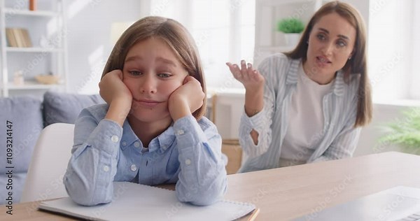 Angry mother scolding sad and upset son at home, showcasing a moment of family conflict or quarrel. Parenting challenges and the dynamics of family relationships in a domestic setting.