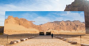 mirrored concert hall appears as a giant mirage in the desert landscape of saudi arabia