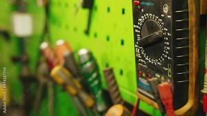 Man using multimeter switches voltage measurement parameters on the multimeter