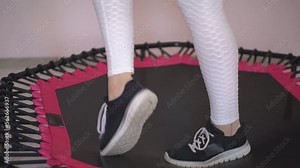 girl jumping on a trampoline in the gym. High quality Full HD video recording