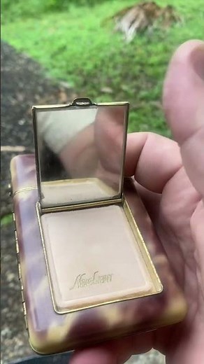 A cool cigarette case from the 60s that includes a vintage lighter make up case and cigarette holder