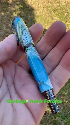 This pen was made using rare garbage truck Fordite. 🚛🗑️ #rusticstarwoodworks #fordite #oneofakind #pen #penaddict #artisan #writer #rollerballpen #garbagetruck #handmade #john316 | Rustic Star Woodworks