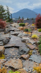 When a backyard overlooks a valley of winding rivers and towering mountains, the view alone feels like a masterpiece. Our goal here wasn’t to compete with that majesty - but to create something that belongs within it. We let the landscape guide us - now a waterfall spills into a winding stream, embraced by beautiful plants and quiet stone paths that meander to a firelit patio. Every detail is gentle, natural, and in harmony - a space with such a captivating view you'll never want to leave home. 