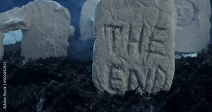 close-up of the inscription the end on the tombstone of an ancient cemetery at night.